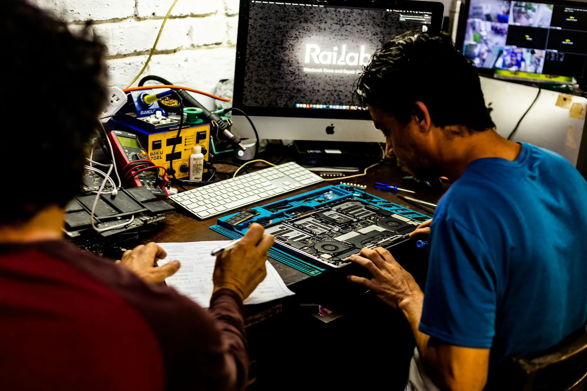 Engineers inspecting a control mainboard at a workbench