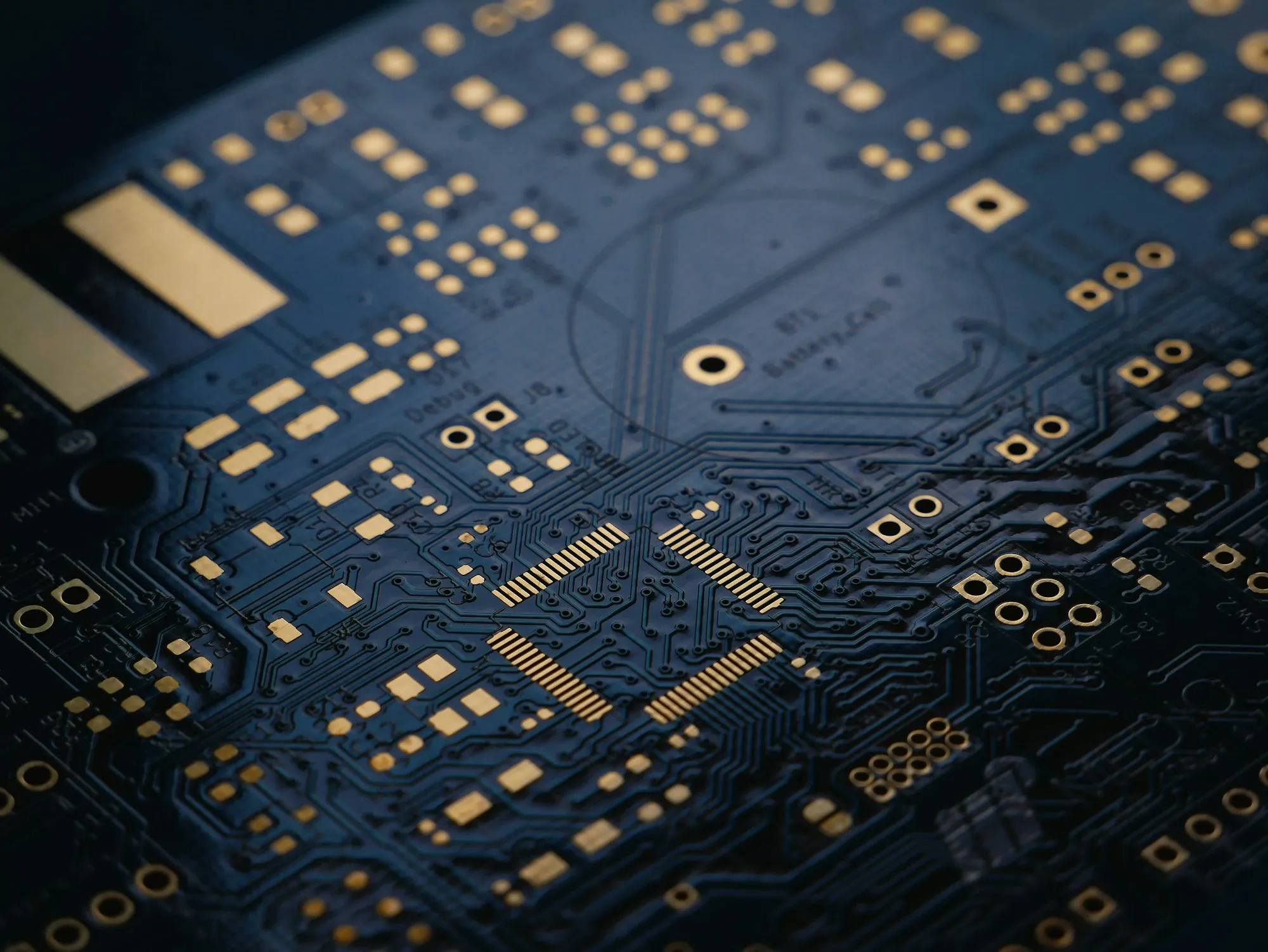 Component and trace detail on a dark blue control board